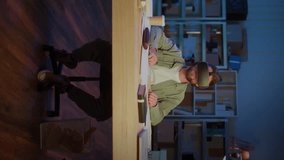 Vertical Video Bearded Man Wearing Virtual Reality Headset While Sitting At Desk With Laptop And Papers. Concept of Digital Innovation, Future Technology, VR Simulation, Remote Work - Powered by Shutterstock - Get 15% off with code: PIKWIZARD15