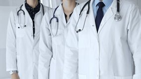 Medical team standing with arms crossed, focusing on healthcare professionals in white lab coats, representing medicine, expertise, and unity in a clinic setting - Powered by Shutterstock - Get 15% off with code: PIKWIZARD15