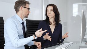 Businessman and business woman colleagues collaborating on computing project in office, discussing data, sharing ideas, and developing solutions, fostering teamwork and professional partnership - Powered by Shutterstock - Get 15% off with code: PIKWIZARD15