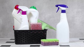 Cleaning Supplies In A Black Basket With Spray Bottles, Sponges, And Scrub Pad - Powered by Shutterstock - Get 15% off with code: PIKWIZARD15
