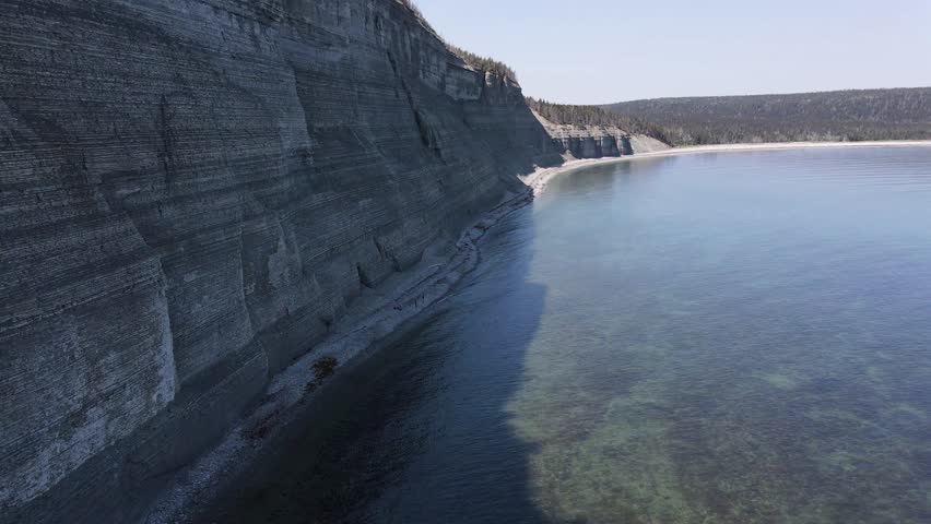 The Tower Point (Pointe de la Tour) is Surrounded by Rocky Cliffs, and the Beach is Composed of Pebbles and Turquoise Water in Anticosti Island, Quebec, Canada
