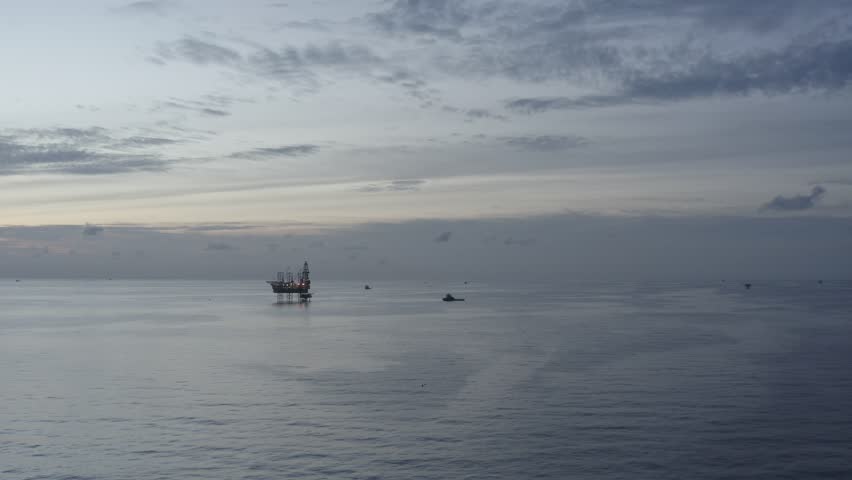 Aerial view of offshore jack up rig and offshore platform during sunset for oil and gas exploration and production. 
