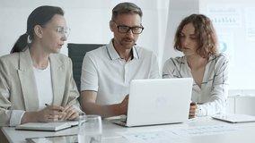 Professional team analyzing data on laptop, sharing insights during collaborative office meeting, highlighting workplace synergy and strategic planning - Powered by Shutterstock - Get 15% off with code: PIKWIZARD15