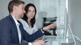 Business colleagues analyzing financial data on computer, discussing project statistics and market trends in office meeting. Businesspeople concept - Powered by Shutterstock - Get 15% off with code: PIKWIZARD15