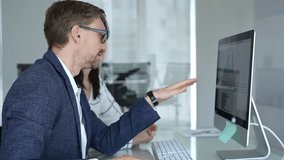 Business colleagues collaborating on data analysis, watching financial graphs and charts on computer monitor. Businesspeople concept - Powered by Shutterstock - Get 15% off with code: PIKWIZARD15