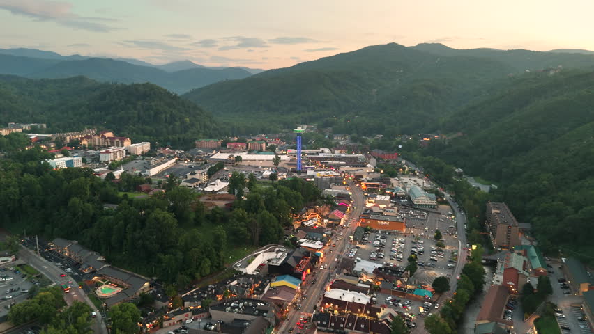 Evening Gatlinburg, scenic mountain town in Tennessee with illuminated Parkway full of restaurants, souvenir shops and entertainment venues in Appalachian region.