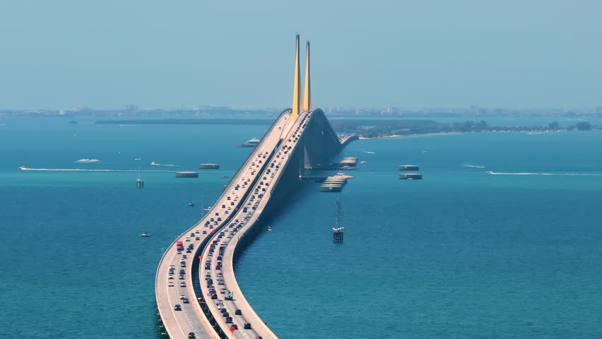 Sunshine Skyway Bridge over Tampa Bay in St Petersburg in Florida with driving traffic cars. Transportation infrastructure in USA