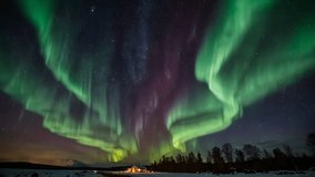 A spectacular view of the Aurora Borealis (Northern Lights), dancing across the dark, starry night sky. Curtains of bright green light dominate, with a touch of reddish purple in the center. - Powered by Shutterstock - Get 15% off with code: PIKWIZARD15