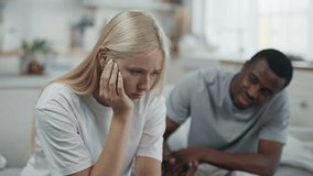Family relationship, multiethnic loving couple quarrelling in kitchen at home. Beautiful blonde woman feeling sad and depressed, african american boyfriend exerts psychological pressure, portrait - Powered by Shutterstock - Get 15% off with code: PIKWIZARD15