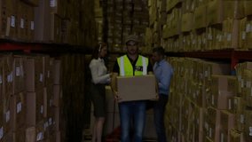 Male warehouse worker walking with package, spawning holographic rings for logistics tracking. Industrial, technology, logistics, warehouse, futuristic, collaboration, supply chain - Powered by Shutterstock - Get 15% off with code: PIKWIZARD15