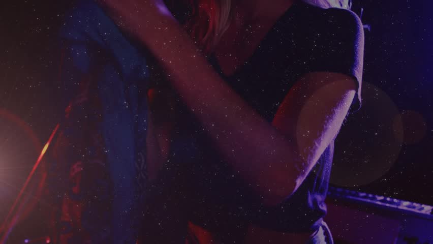 Female singer stepping under musical stage lights, grasping mic and performing emotively. Performance, vocal, concert, entertainment, artistic, stage, expressive