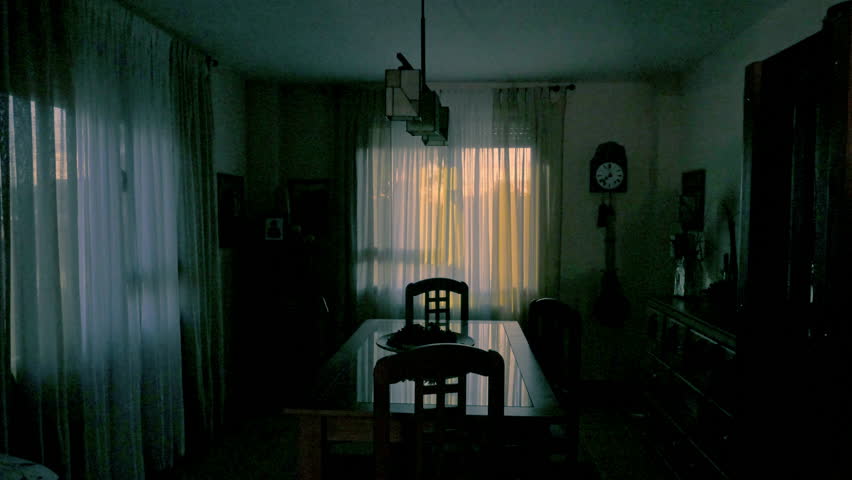 Sunrise time-lapse of a cozy dining room with a wooden table and chairs, soft curtains, vintage decor, and a classic clock. The warm lighting creates a cozy, family-friendly atmosphere.