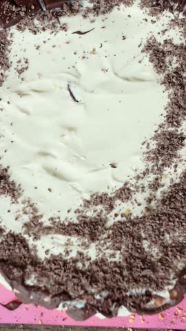 Sprinkle grated chocolate on top of the cake.