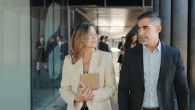 Business people colleagues walking and talking in a busy office during international convention congress - Powered by Shutterstock - Get 15% off with code: PIKWIZARD15