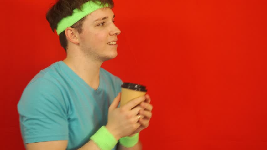 An attractive man drinks hot coffee