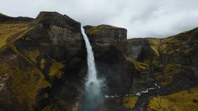 FPV drone diving dramatically over Haifoss, one of Iceland’s tallest and most breathtaking waterfalls. Rugged cliffs, and powerful cascades surrounded by untouched volcanic landscapes. Cinematic video - Powered by Shutterstock - Get 15% off with code: PIKWIZARD15