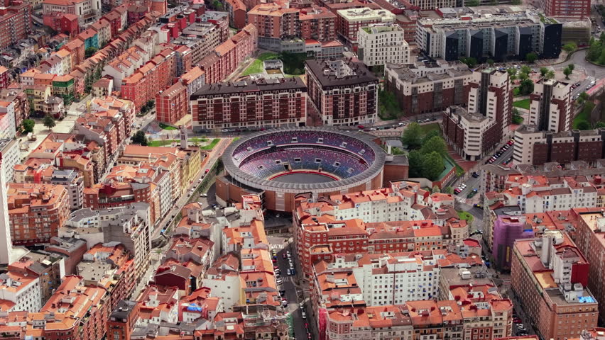 Majestic aerial view of iconic Plaza de Toros de Vista Alegre bullring, nestled amidst vibrant cityscape of Bilbao, Spain