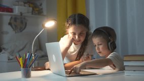 Woman and child using laptop. Children learning in distance. Child is learning how to do homework on a laptop. A lifestyle girl and a woman operating a laptop. - Powered by Shutterstock - Get 15% off with code: PIKWIZARD15