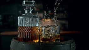 Super Slow Motion of Ice Cube Falling into Glass of Whiskey with Camera Motion. Filmed on High Speed Cinema Camera, 1000 fps.  - Powered by Shutterstock - Get 15% off with code: PIKWIZARD15