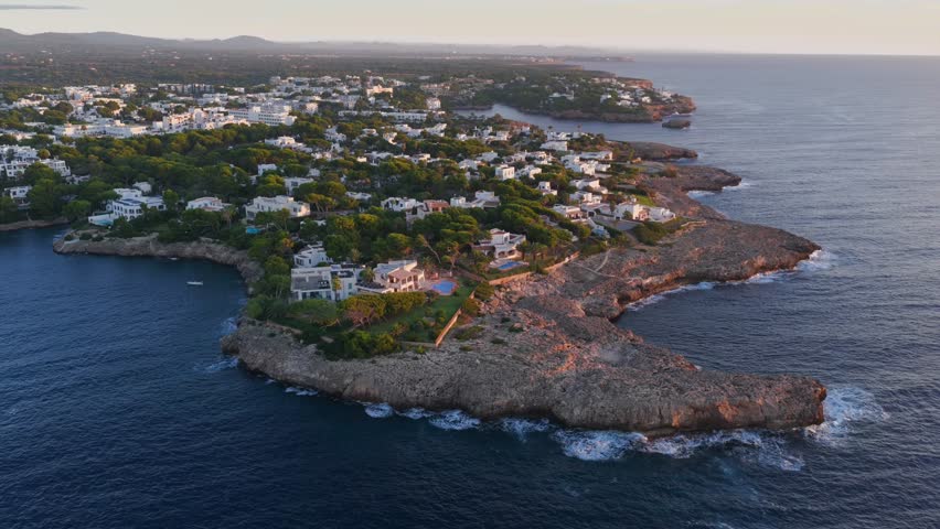 Aerial Sunrise Over Cala d'Or: Multiple Coves, Yachts, and Resort Town on Mallorca's Coast
