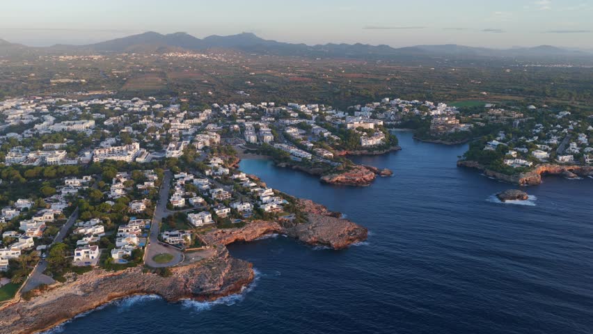 Aerial Sunrise Over Cala d'Or: Multiple Coves, Yachts, and Resort Town on Mallorca's Coast