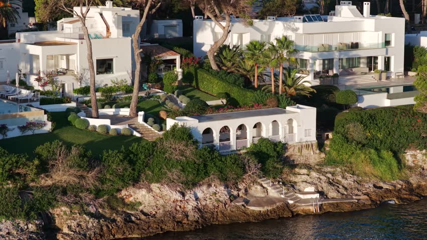Aerial Sunrise Over Cala d'Or: Multiple Coves, Yachts, and Resort Town on Mallorca's Coast