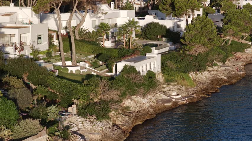 Aerial Sunrise Over Cala d'Or: Multiple Coves, Yachts, and Resort Town on Mallorca's Coast