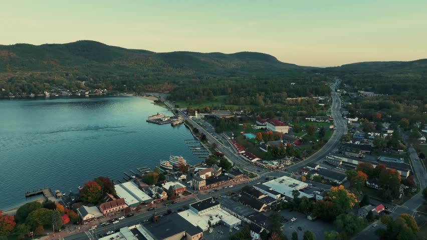Adirondack Mountain, New York State. Aerial view of a coastal town with a river and mountains in the background.