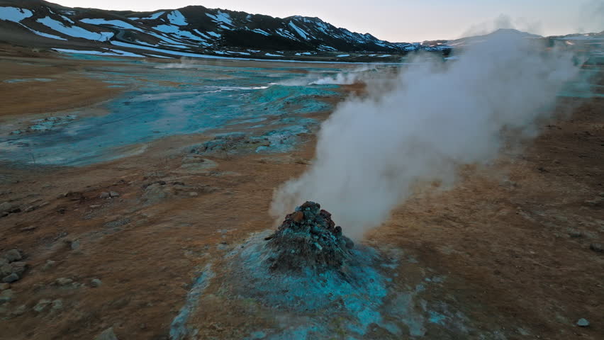 Drone footage of Hverir geothermal area near Lake Mývatn, North Iceland. Steam vents and mud pots bubble in the evening light.