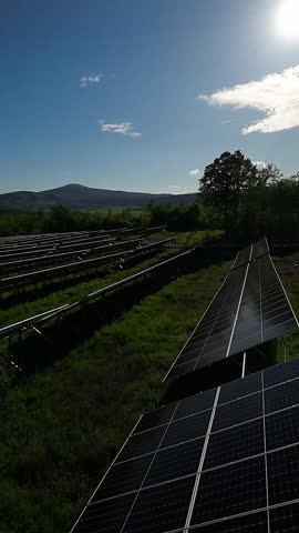 Solar panels in a large photovoltaic power station under a clear blue sky, renewable energy concept with sustainable technology for clean electricity production.