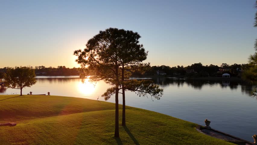 Aerial view of a peaceful lake by sunset  next to luxurious neighborhood by Woodlands lake , Houston, Texas.