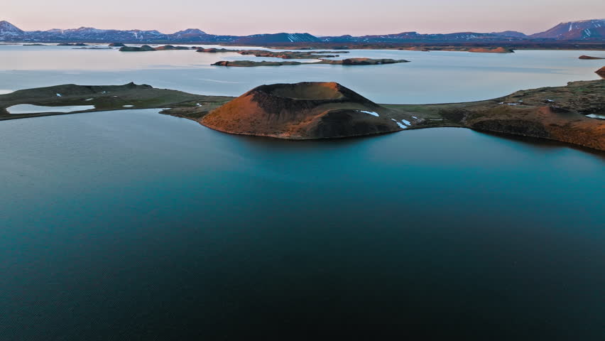 Close aerial view of volcanic crater at Lake Myvatn, North Iceland. Evening light casts long shadows across the circular rim.