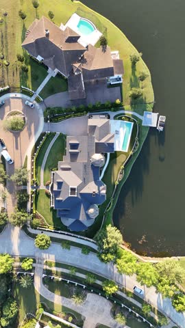 Aerial view of luxurious house with swimming pool by the lake
