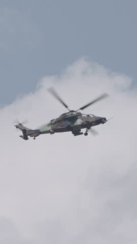 Vertical footage of a military helicopter performing combat flight maneuvers