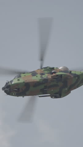 military helicopter performing combat flight maneuvers
