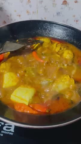 
Spicy sour fish is being cooked in a wok, spicy sour is a typical Malay dish