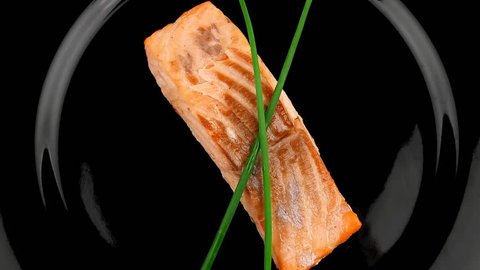 healthy fish cuisine : baked pink salmon steaks with green onion on black dish 1920x1080 intro motion slow hidef hd
