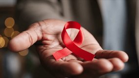 Hand Holding Red Ribbon for World AIDS Day World AIDS Day Red Ribbon Awareness Advertisement - Powered by Shutterstock - Get 15% off with code: PIKWIZARD15