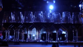 Red wine in glasses at a party. Beautifully shiny glasses of white and red wine sparkle against the background of illumination. Wine glasses with good lighting. A waiter pours wine into glasses in a - Powered by Shutterstock - Get 15% off with code: PIKWIZARD15