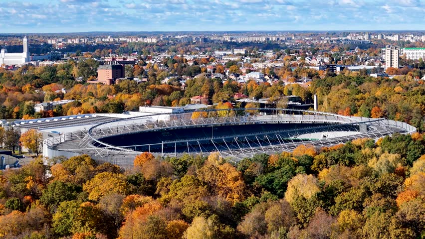 Kaunas Darius and Girenas football stadium, Lithuania. Aerial drone 4K video footage of a multi-use stadium in Azuolynas oak grove park in autumn