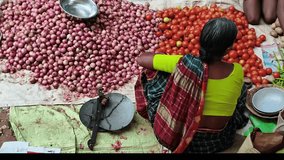 Authentic scene of a woman vendor selling onions and tomatoes at a rural market in India. Captures local culture, traditional attire, Perfect culture, travel and lifestyle themes - Powered by Shutterstock - Get 15% off with code: PIKWIZARD15