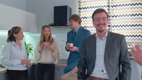 Coworkers gathered in office kitchen, enjoying snacks, sandwiches, and coffee during break time. Relaxed and friendly environment, teamwork spirit, casual business lifestyle. - Powered by Shutterstock - Get 15% off with code: PIKWIZARD15