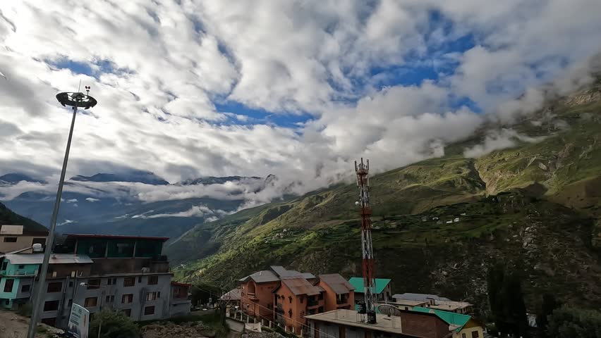 Scenic view of the mountains and valley surrounding Keylong, the north India, filmed from a rooftop, showing the beauty and calm of the Himalayas.