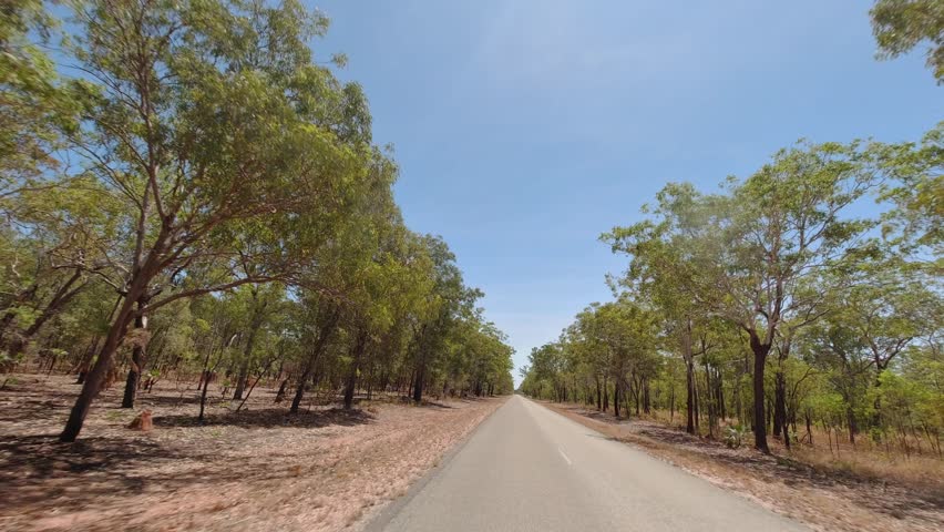 Driving through the arid landscape along the Kakadu Highway near Pine Creek in the Northern Territory