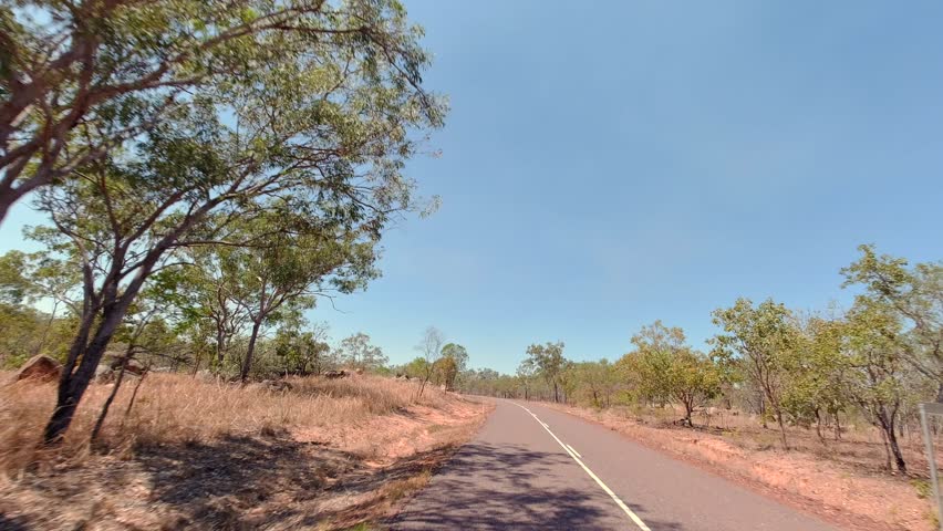 Driving through the arid landscape along the Kakadu Highway near Pine Creek in the Northern Territory