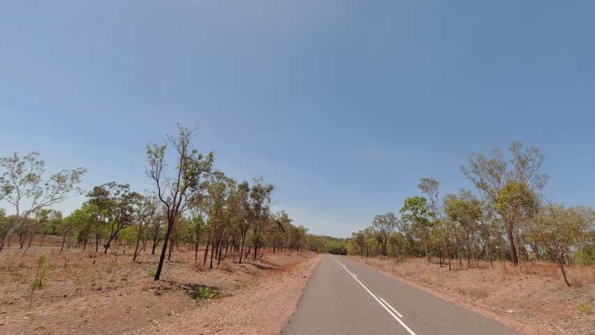 Driving through the arid landscape along the Kakadu Highway near Pine Creek in the Northern Territory