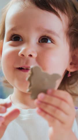 young child displays happiness during tasting, small child eagerly explores and savors sweet biscuit treat