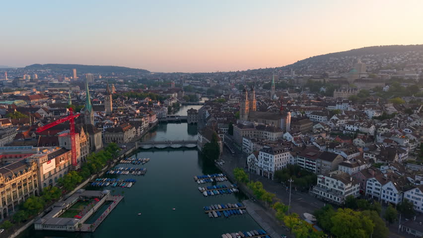 Aerial view of Zurich Cityscape at sunrise, showcasing architecture and city life. Switzerland
