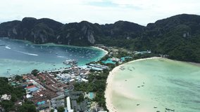 Phi Phi Don Island, a popular tourist destination. A village and pier between two bays, a drone flight over the islands in Thailand. - Powered by Shutterstock - Get 15% off with code: PIKWIZARD15