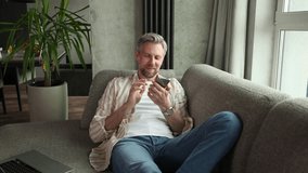 Confident young man holding smartphone near mouth for recording voice message or activating digital assistant. - Powered by Shutterstock - Get 15% off with code: PIKWIZARD15